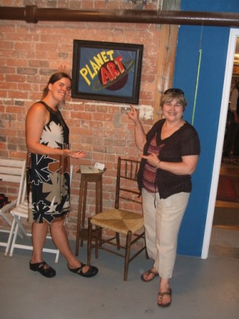 Me and Mom in front of my stellar Planet Art sign and Dave's rush chair