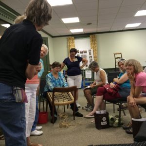 Mical Wilmoth Carton demonstrating Danish Cord weaving on a mid-century chair. chairperson-antiques.com